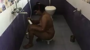 Fat Indian female with a mask on her face performs porn showering